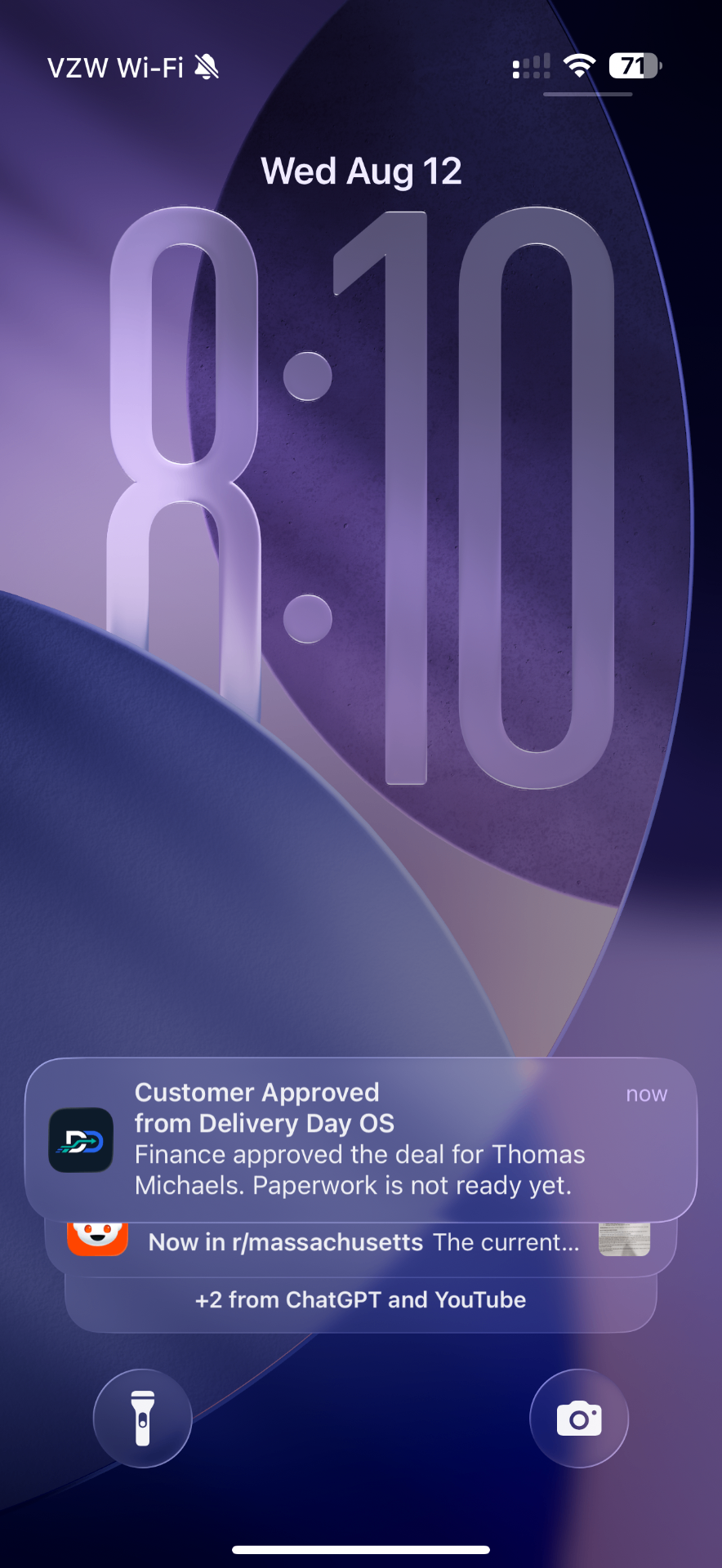 iPhone lock screen showing a Delivery Day OS IQ Alert that finance approved the deal for Thomas Michaels
